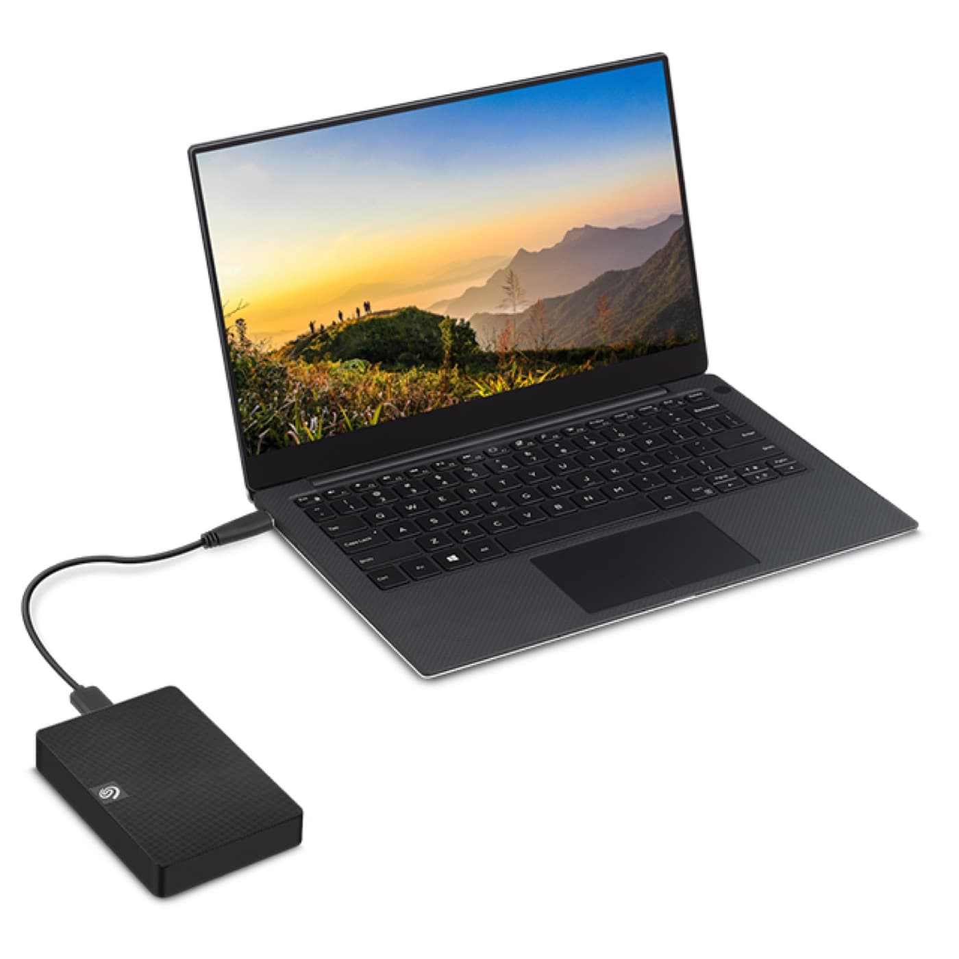 Slim laptop with a Seagate Expansion portable hard drive connected by USB cable.